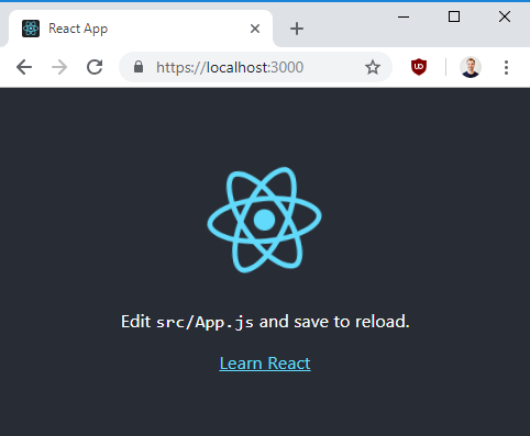 Default screen for create-react-app function. Shows a grey background with a blue atom symbol. Text on the bottom reads: "Edit src/App.js and save to reload
